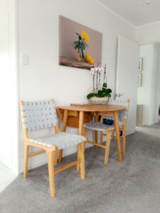 Dinning area with dining table with drop sides and two chairs chairs with wide duck egg blue woven, genuine leather seats